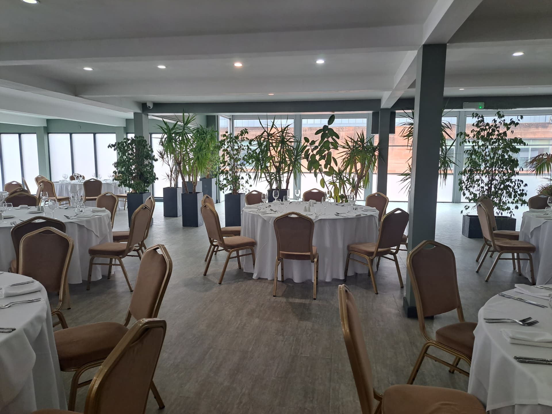 The dining room at Manchester Hall set with round tables for an event